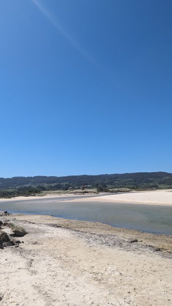 A view of the sandy beach and calm water area at Pedra do Sal.
