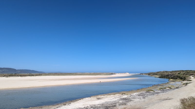 A wide view of the sandy beach and coastal lagoon under a clear blue sky. — Pedra do Sal, A Pedra do Sal, Galicia, Spain