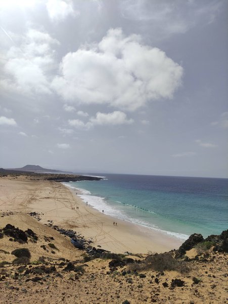 An elevated wide-angle view of Playa las Conchas showing the sandy beach and turquoise water. — Playa las Conchas (La Graciosa), Teguise, Canary Islands, Spain