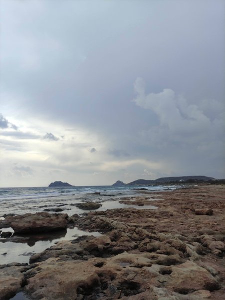 A rocky shoreline at Xerokambos under a cloudy sky. — Xerokambos (Lefki), Lefki Municipal Unit, Greece