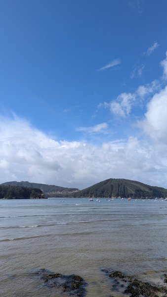 A wide view across the bay showing calm water, distant hills, and several small boats. — Cedeira (Valdoviño), Cedeira, Galicia, Spain