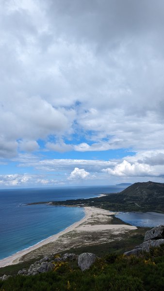 A wide-angle aerial view of the sandy beach and clear blue waters at Ancoradoiro. — Ancoradoiro (Louro), Muros, Galicia, Spain