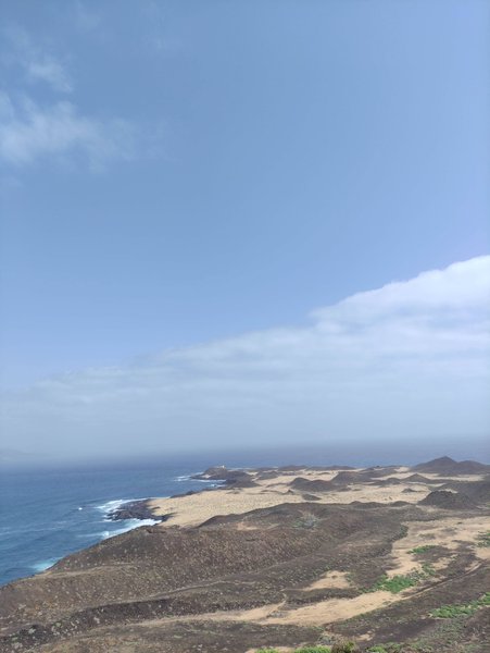 A high-angle view of the rugged coastline and blue waters at El Muelle.
