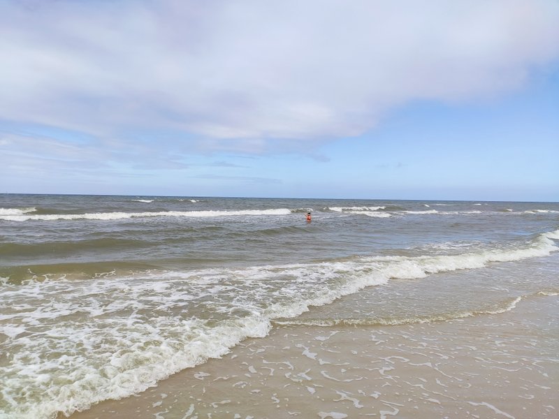 Small waves breaking on the sandy beach under a cloudy sky. — Debki, Karwieńskie Błota, Pomeranian Voivodeship, Poland