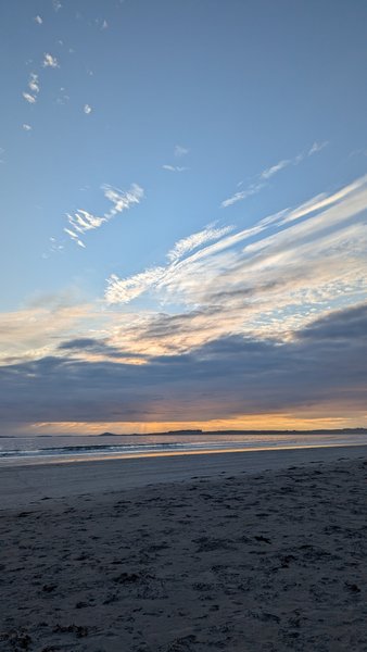 A sunset view across the beach and water at Rosses Point.
