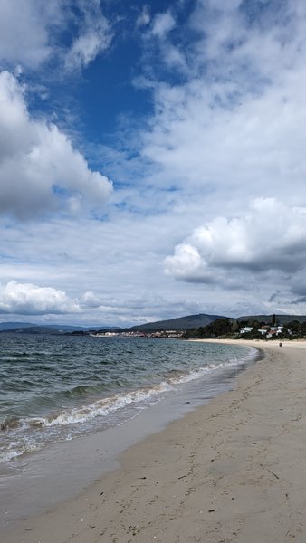 A wide sandy beach with small waves under a cloudy sky. — Aguieira (Noya), O Porto do Son, Galicia, Spain