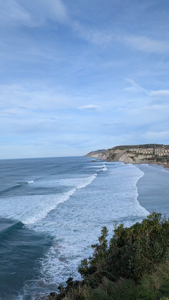 An elevated view of the La Salvaje coastline with waves breaking on the long beach.