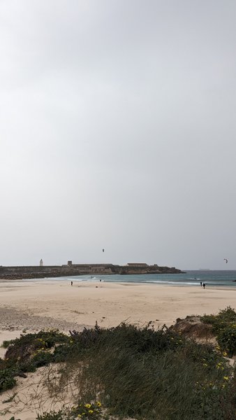 A wide view of Playa Chica in Tarifa with kitesurfers in the distance and Isla de las Palomas in the background. — Playa Chica (Tarifa), Tarifa, Andalusia, Spain