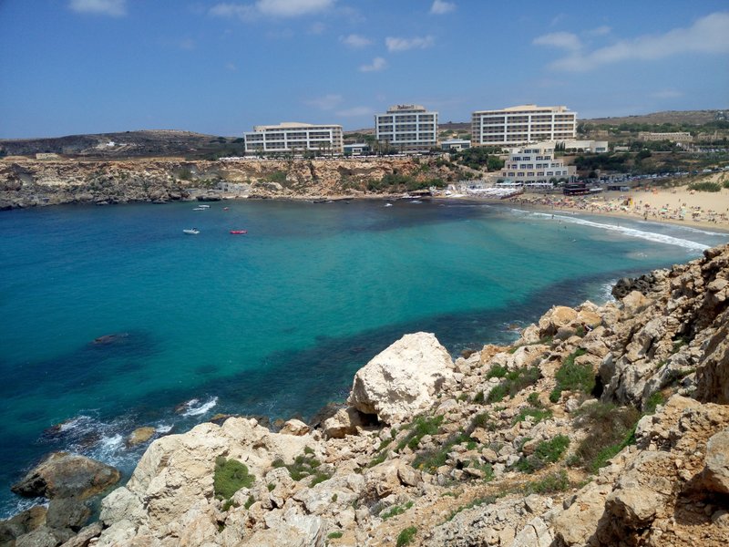 A wide view of Golden Bay showing the beach, clear water, and surrounding cliffs. — Golden Bay (Manikata), Manikata, Malta