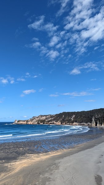 A scenic wide-angle view of Playa de Barayo featuring the sandy beach, breaking waves, and coastal cliffs. — Playa de Barrayo (Otur), Valdés, Asturias, Spain