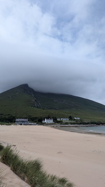 A view of the sandy beach at Doogort with Slievemore mountain partially covered in clouds. — Doogort (Achill Island), County Mayo, Westport-Belmullet Municipal District, Ireland