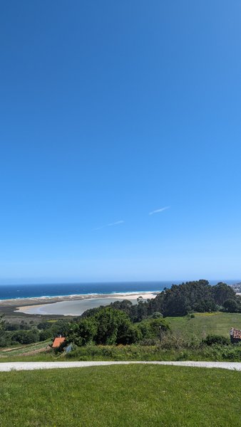 A wide landscape view showing the Playa de Razo coastline from a distance. — Praia de Razo (Bergantiños), As Areas, Galicia, Spain