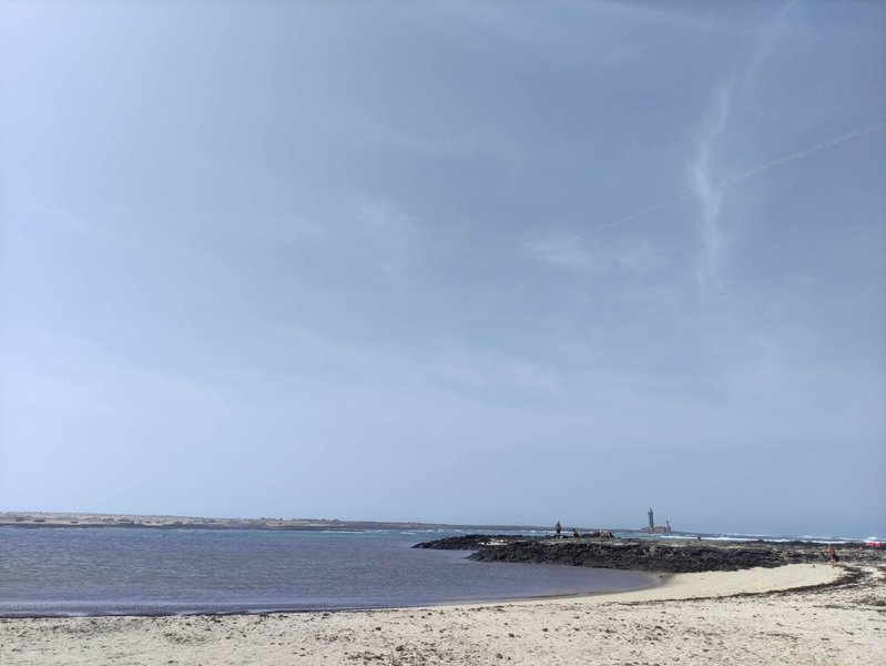 A view of the sandy beach and tidal lagoon at Los Charcos under a clear sky. — Los Charcos (Fuerteventura), La Oliva, Canary Islands, Spain