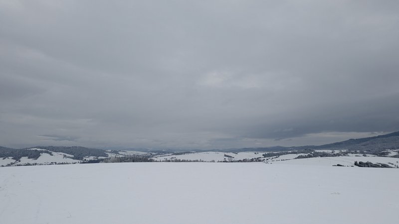 A vast snow-covered landscape under an overcast sky with distant hills. — Oravske Vesele, Oravské Veselé, Slovakia