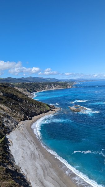 A high-angle view of the rugged coastline and sandy beach at Playa de San Pedro. — Praia de San Pedro (Cudillero), Cudillero, Asturias, Spain