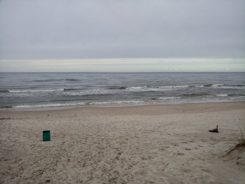 A wide view of the sandy beach and Baltic Sea at Łeba.