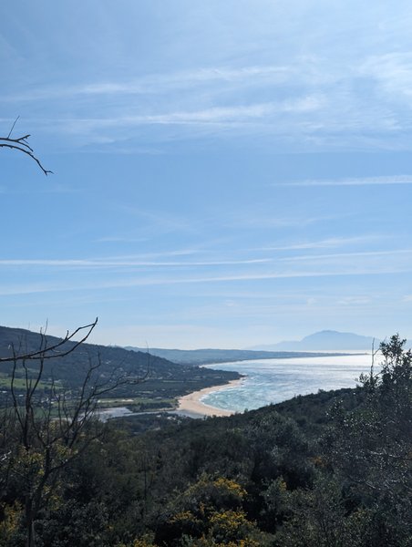 A panoramic view of the beach and bay at Punta Paloma from an elevated vantage point.