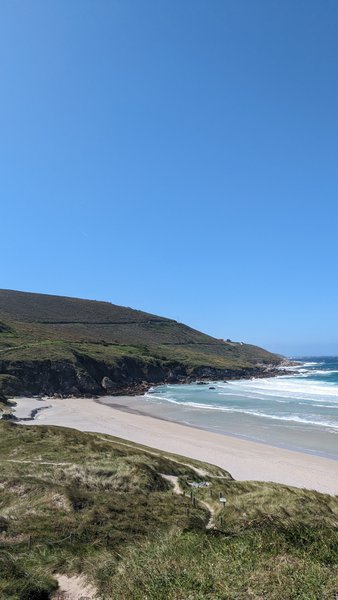 A wide view of Playa de Seaia showing the sandy beach, waves, and surrounding hills. — Playa de Seaia (Bergantiños), Malpica, Galicia, Spain