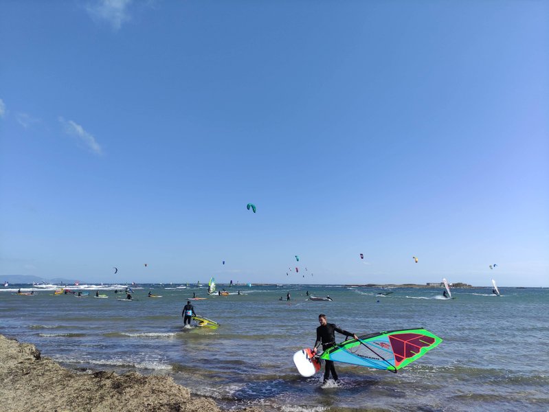 Windsurfers and kitesurfers active on the water at Nissakia Loutsa.
