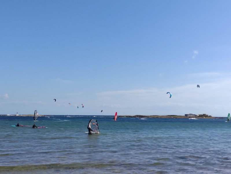 Windsurfers and kitesurfers active on the water at Nissakia Loutsa.
