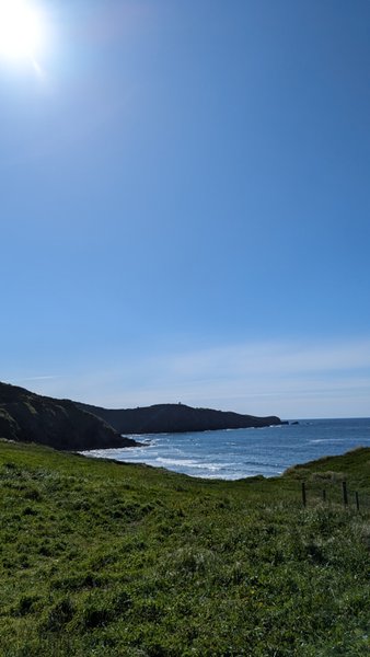 A view of the bay and coastline at Playa Tenrero under a clear blue sky. — Playa Tenrero (Gozón), Gozón, Asturias, Spain