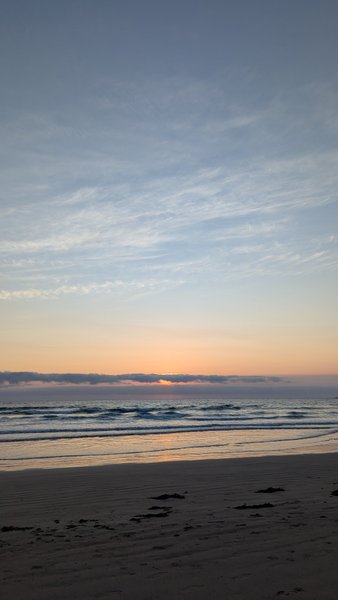 A view of the waves and beach at Stoney Gap during sunset.