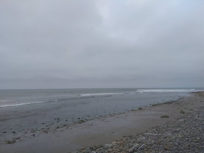 Overcast view of the shoreline and small waves at Emma Wood State Beach.