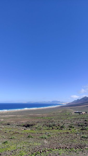 A wide panoramic view of Cofete Beach and the surrounding mountainous landscape. — Cofete (Praia de Cofete), Cofete, Canary Islands, Spain