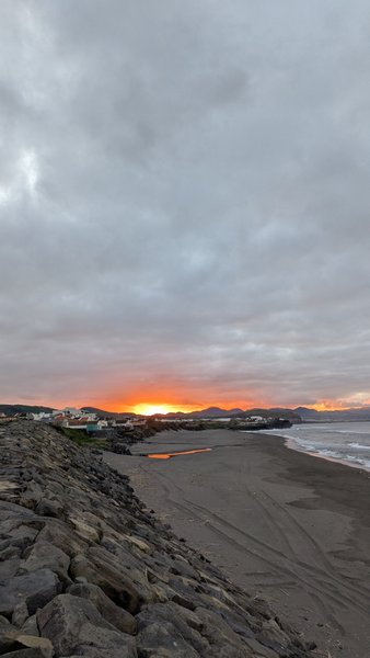 View of the dark sand beach at Monte Verde under a cloudy sunset sky. — Monte Verde (São Miguel), Ribeira Grande, Portugal