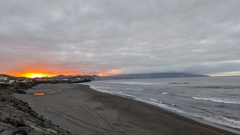 A wide view of Monte Verde beach at sunset with breaking waves and dark sand. — Monte Verde (São Miguel), Ribeira Grande, Portugal