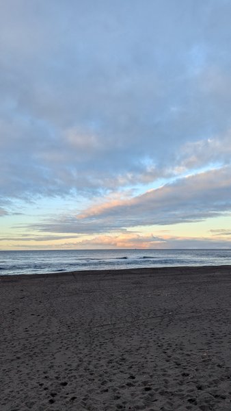 View across the dark sand beach toward the ocean at Monte Verde. — Monte Verde (São Miguel), Ribeira Grande, Portugal