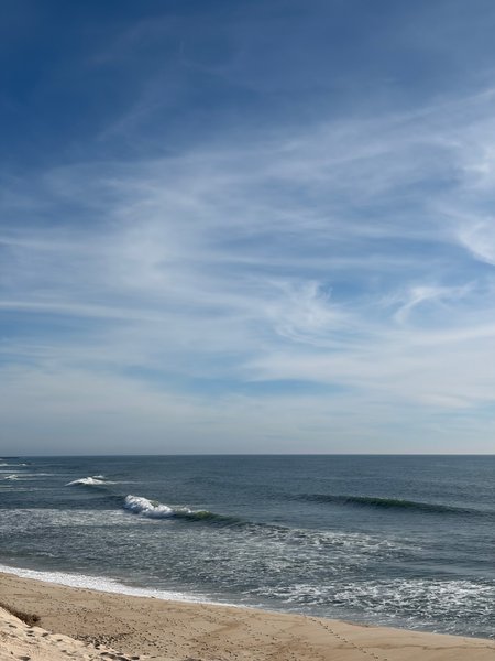 A view of the coastline and breaking waves at Praia do Areão.