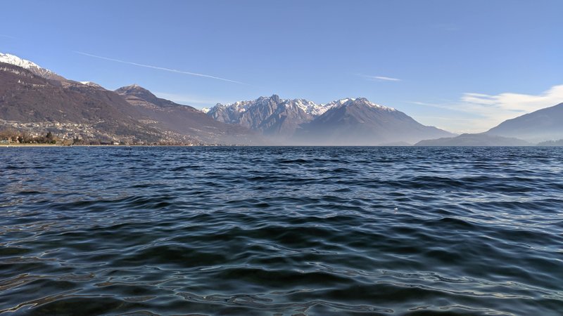 A wide view across Lake Como from Dongo towards the snow-capped mountains. — Dongo (Lake Como), Dongo, Lombardy, Italy