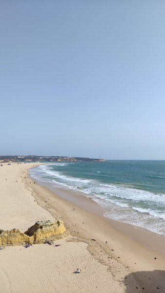 A high-angle view of the wide sandy beach and surf at Praia da Rocha. — Praia da Rocha (Lagoa), Lagoa, Portugal