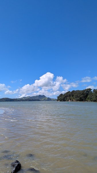 A wide shot of calm water with distant hills under a clear blue sky. — Whitianga (Coromandel), Thames-Coromandel District, Waikato, New Zealand